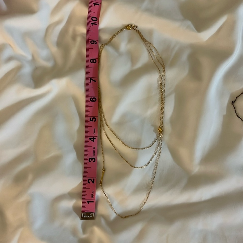 Gold three layer chain necklace with gold and arrow detail